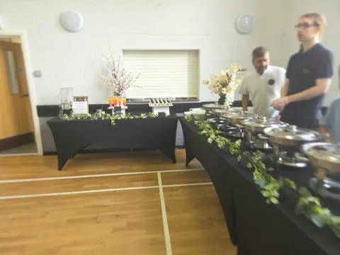 Our serving line laid out along a community hall.