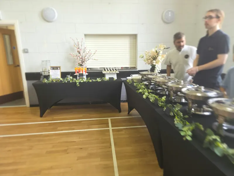 Our serving line running the length of a community hall, chafing dishes along one side and drinks on the other.