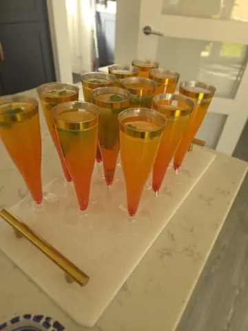 Welcome drinks poured into gold-rimmed flutes and set out on a marble tray.